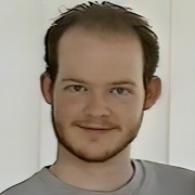 Man with facial hair and a receding hairline